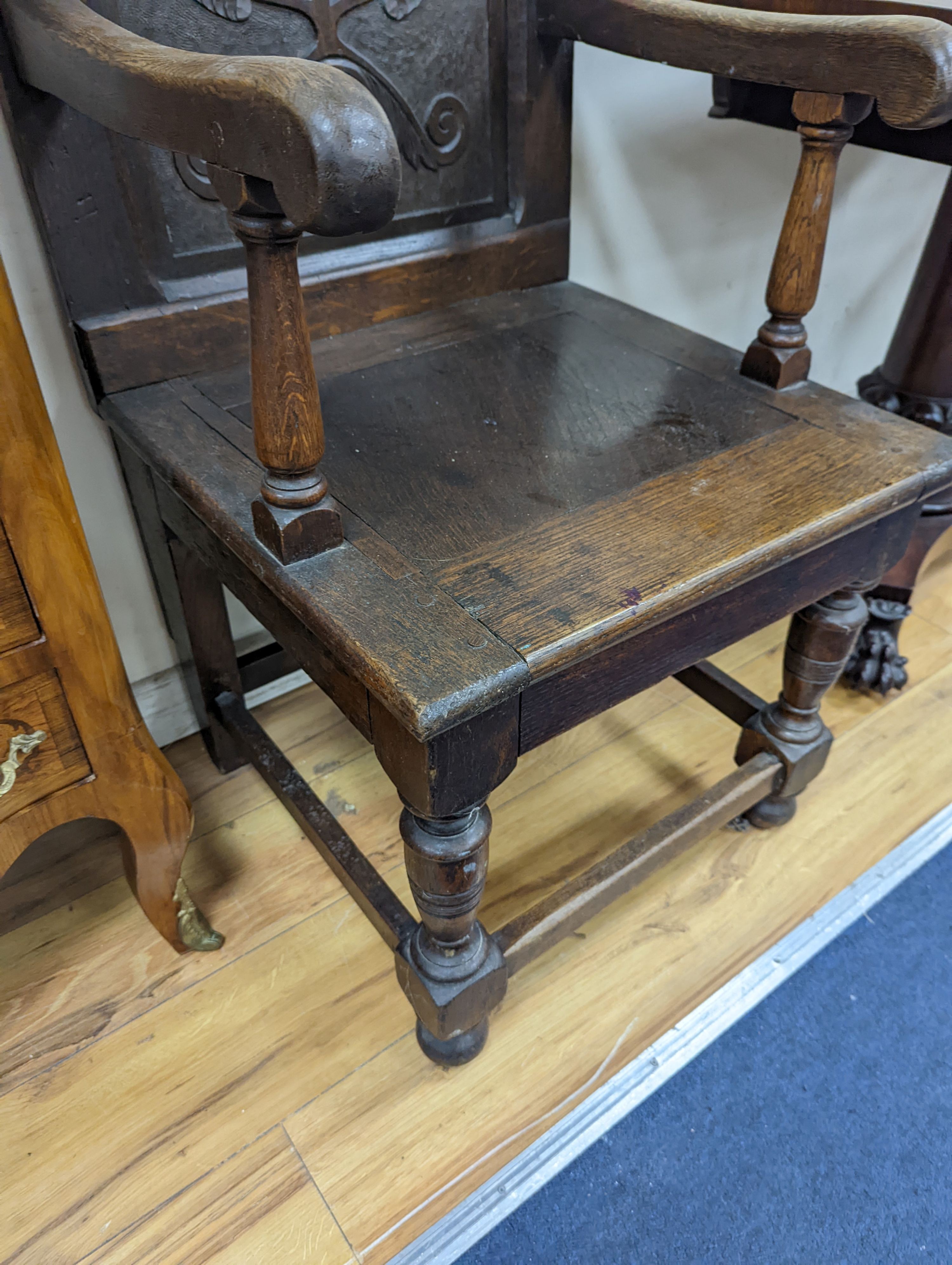 A 17th century style oak wainscot chair, width 54cm, height 122cm